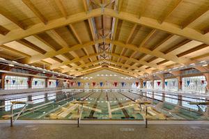 Wood framed roof over aquatic center pools